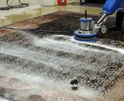 Professional rug cleaning with a rotary floor machine and shampoo foam, deep-cleaning an area rug, in Long Beach, CA.